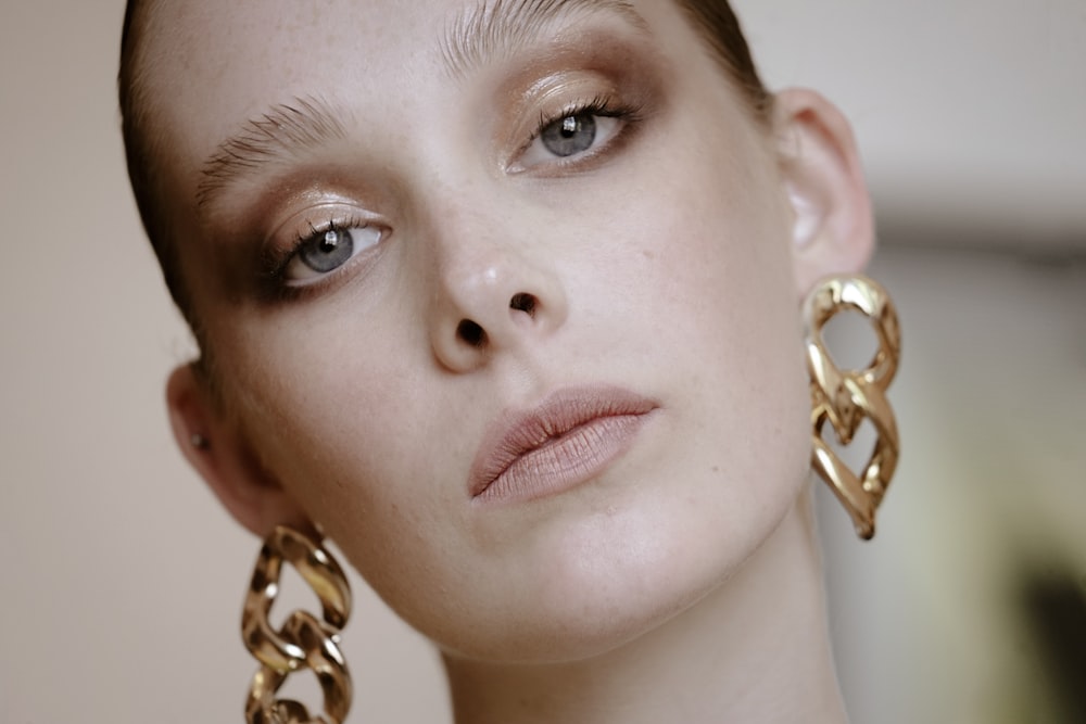 a close up of a person wearing large earrings