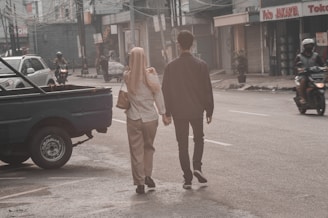 a man and a woman walking down a street