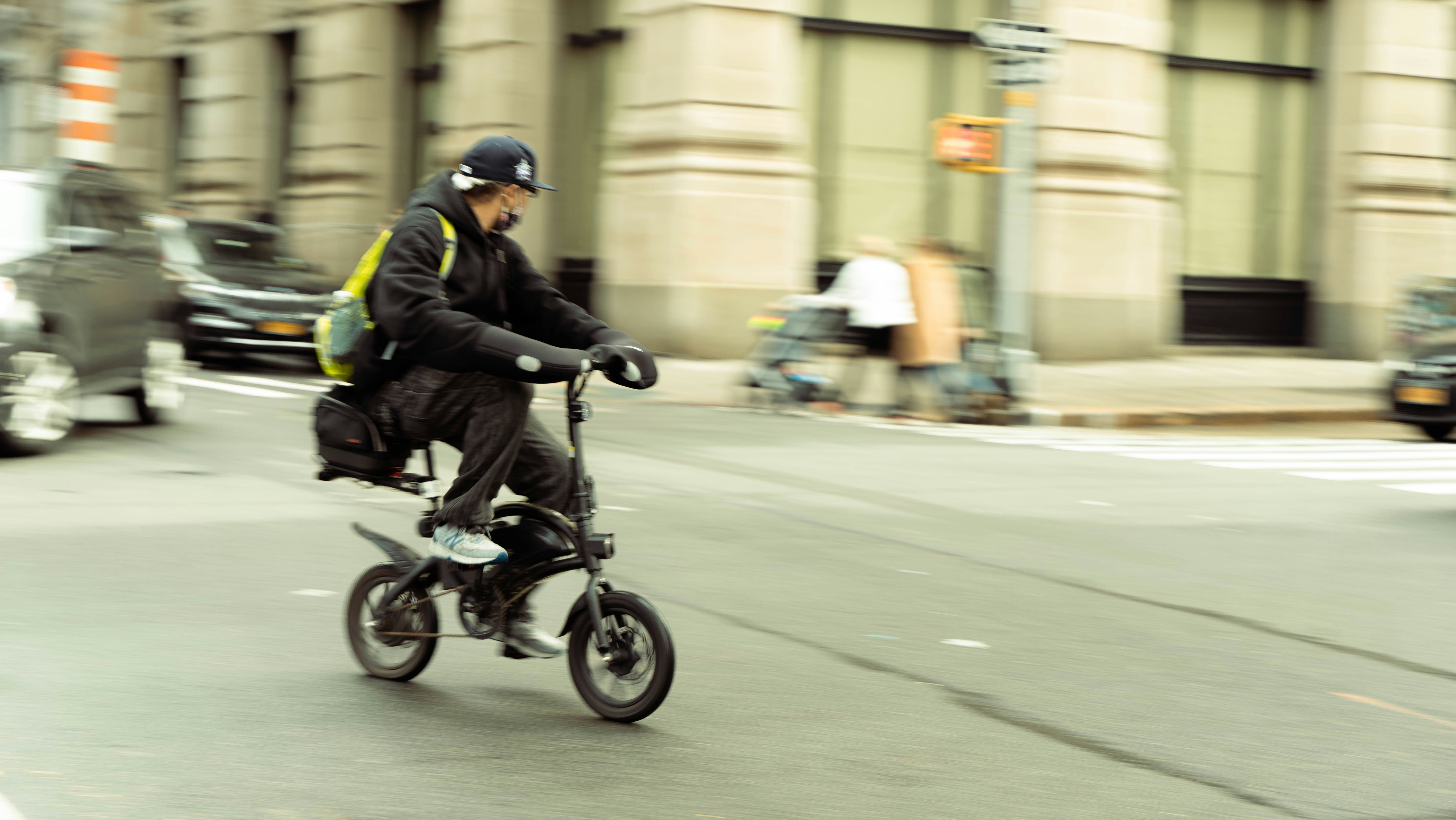 a man riding a bike down a city street