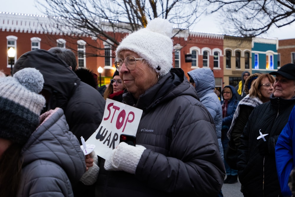 a group of people standing around each other holding signs