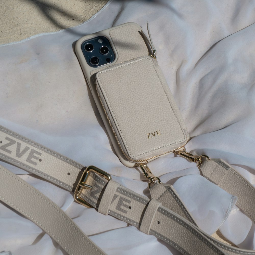 a cell phone sitting on top of a white bag