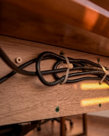 A bright workspace featuring neatly organized cables and lighting components on a navy blue background.