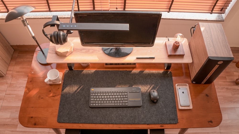 a computer desk with a keyboard and mouse