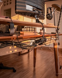 Person setting up electronic devices in a home office environment.