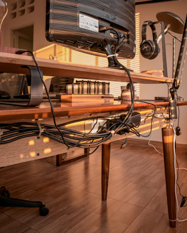 A cozy home office setup with a headset and notes about phone and broadband plans.