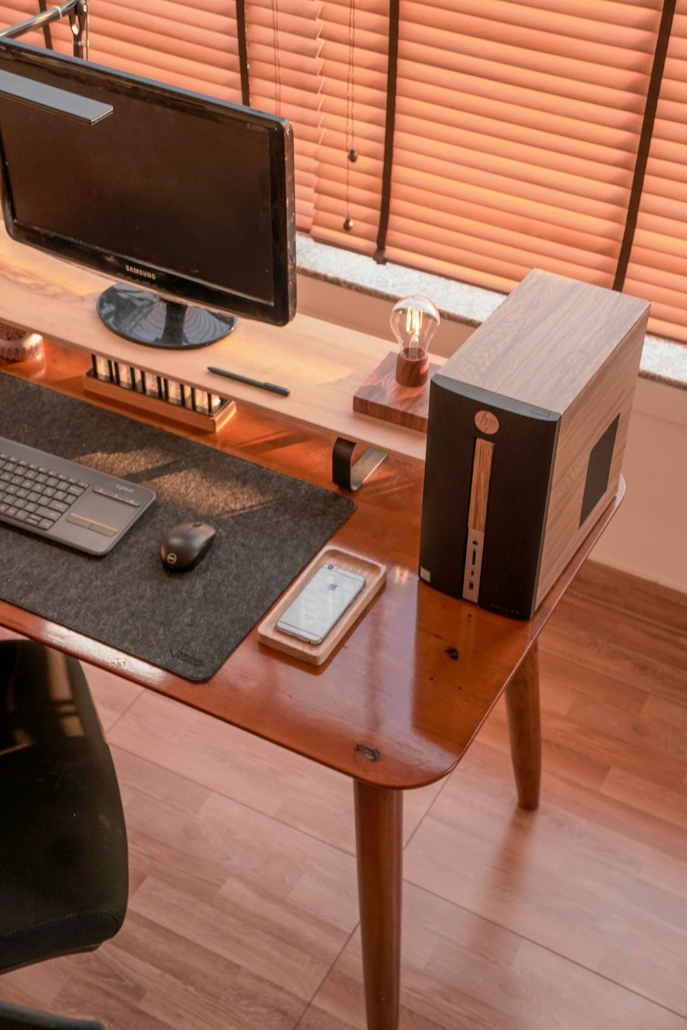 a computer desk with a monitor, keyboard and mouse