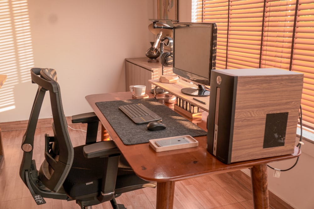 a computer desk with a monitor, keyboard and mouse