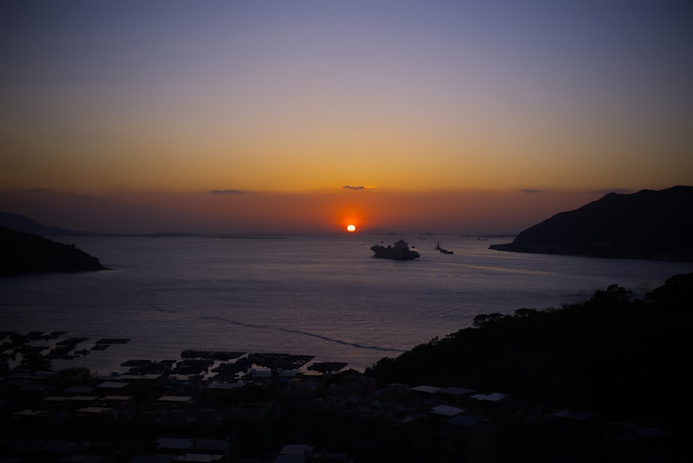 a sunset over a large body of water