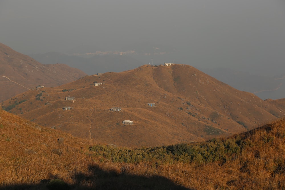 a view of a hill with a few houses on it