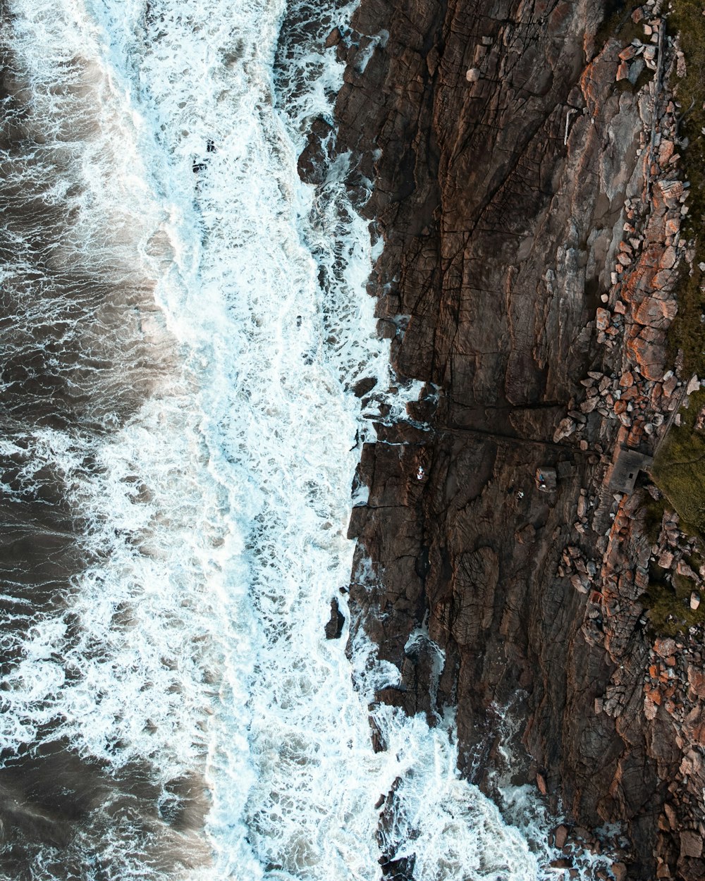 an aerial view of the ocean and cliffs