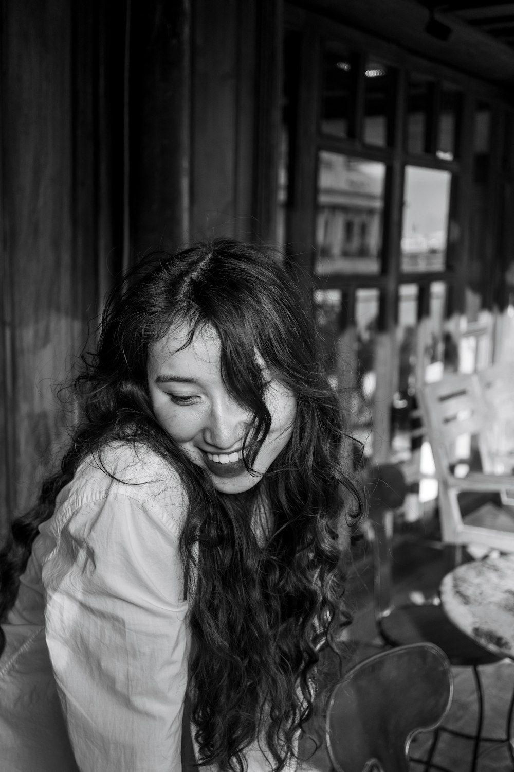 a woman sitting at a table with a smile on her face