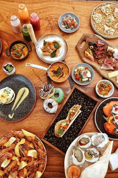 a wooden table topped with plates of food