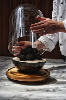 a person holding a bowl with food inside of it