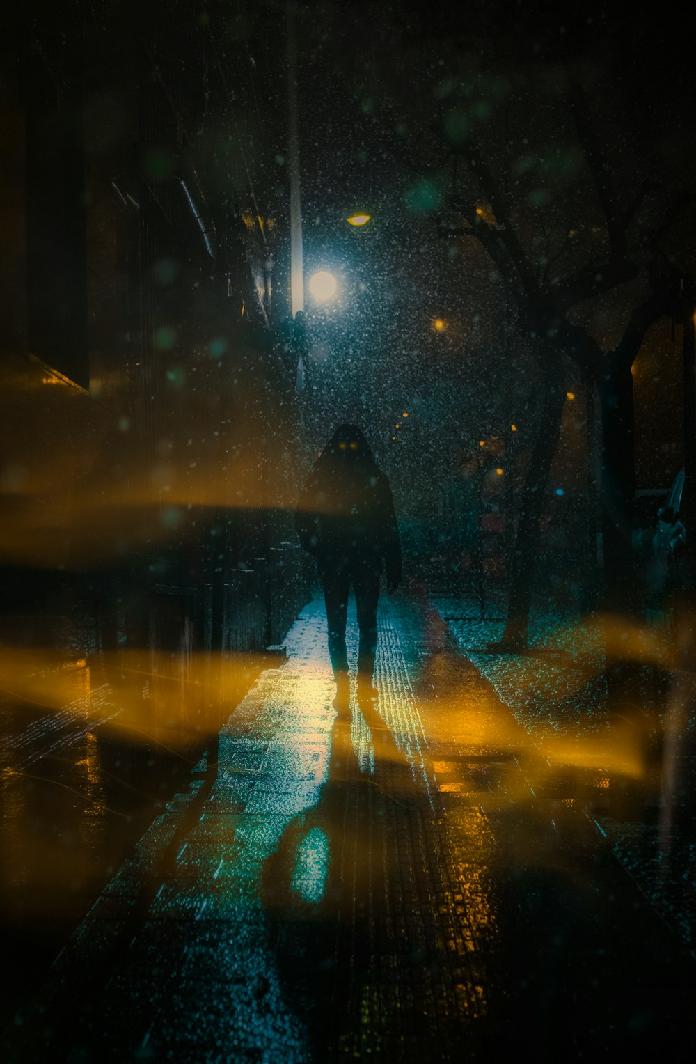 a person walking down a street at night