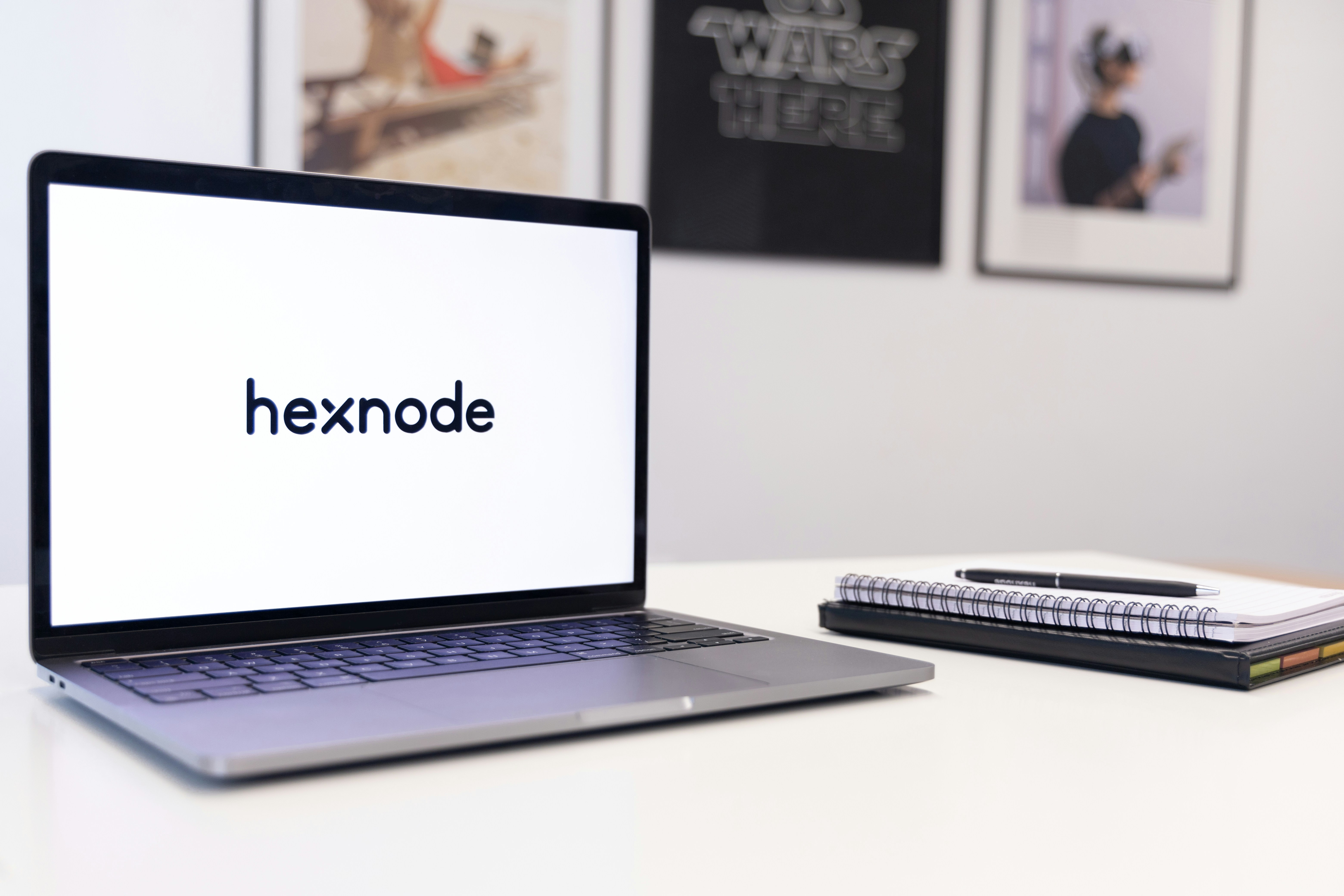 a laptop computer sitting on top of a white desk