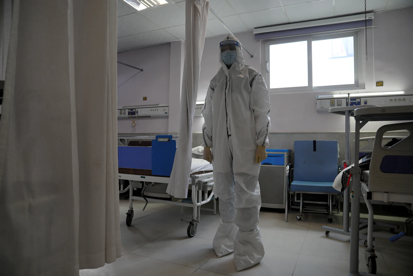 Health workers in protective medical equipment, used as contextual imagery for an Ebola outbreak response story.