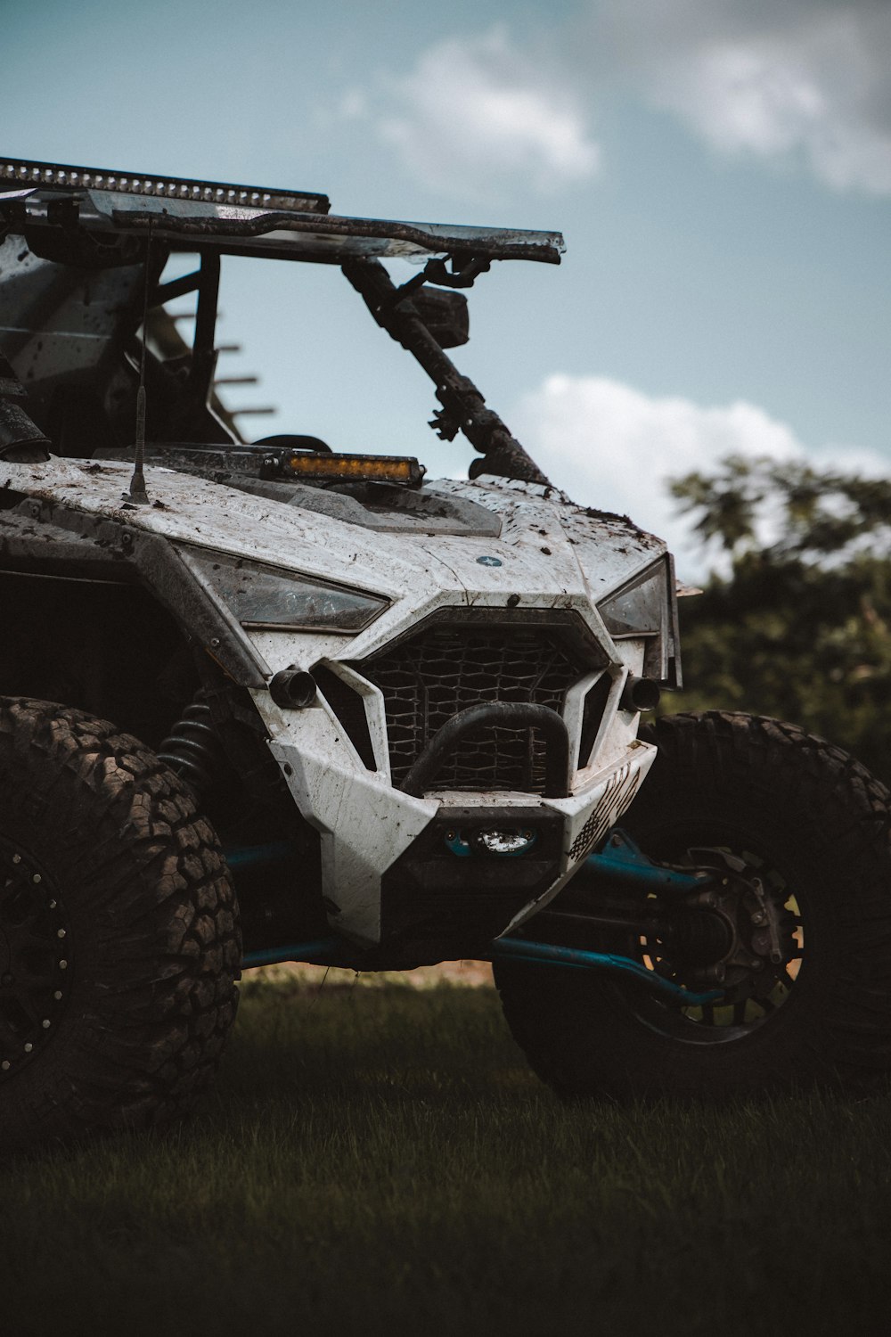 a white four - wheeled vehicle parked in the grass