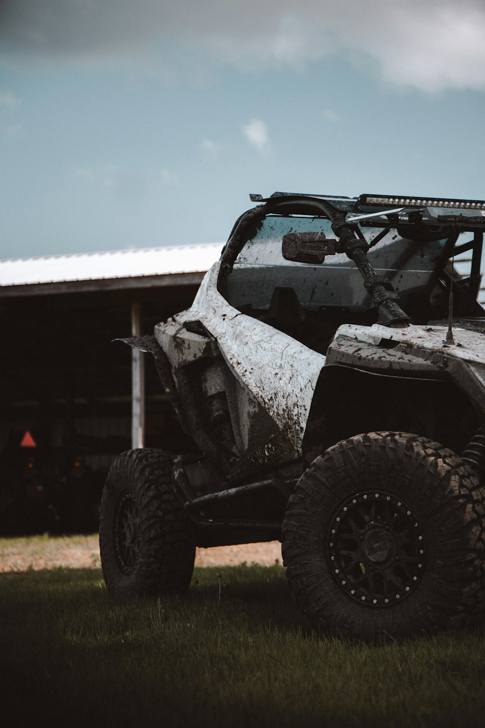 a can - am commander off - road vehicle parked in front of a building