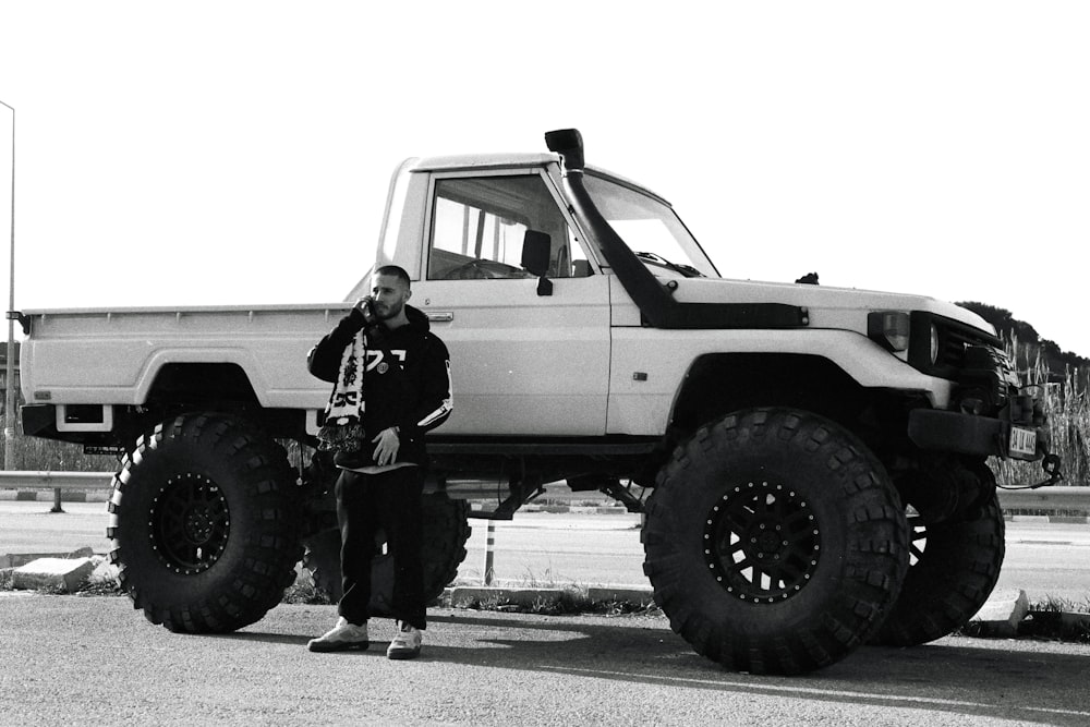 a man standing in front of a large truck