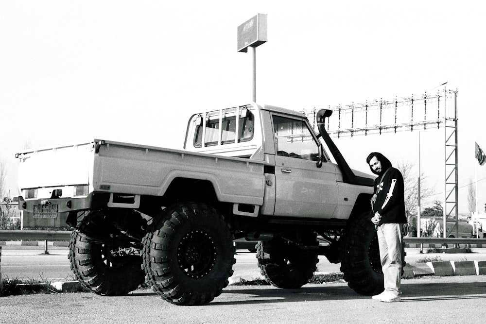 a man standing next to a white truck