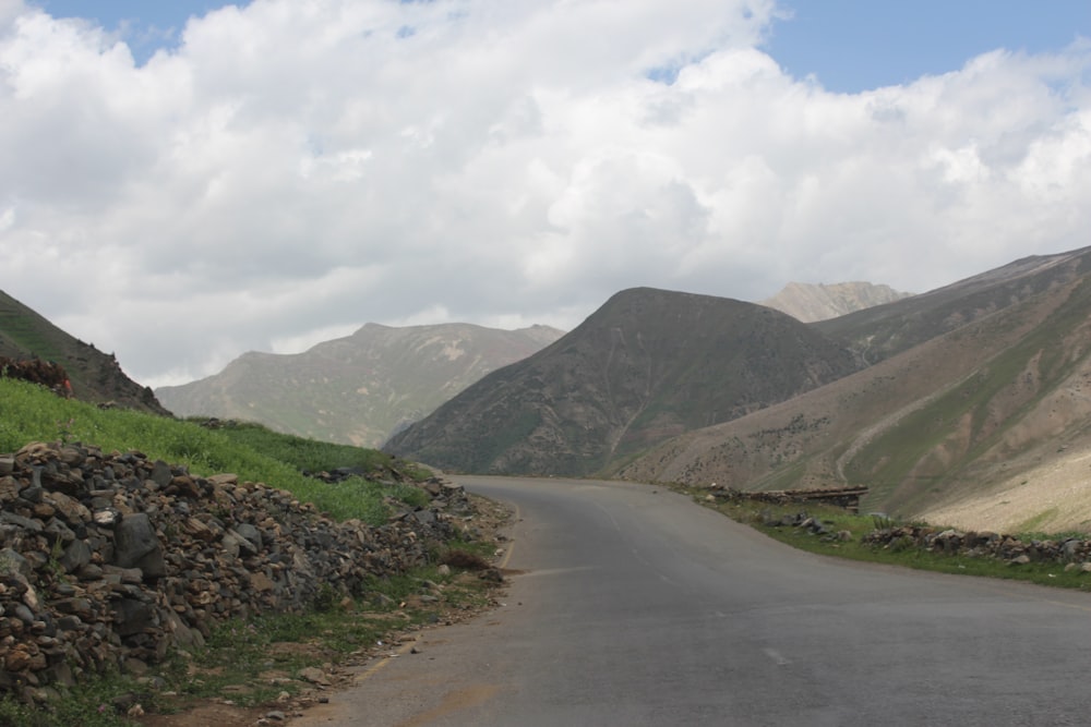 a long road with a mountain in the background