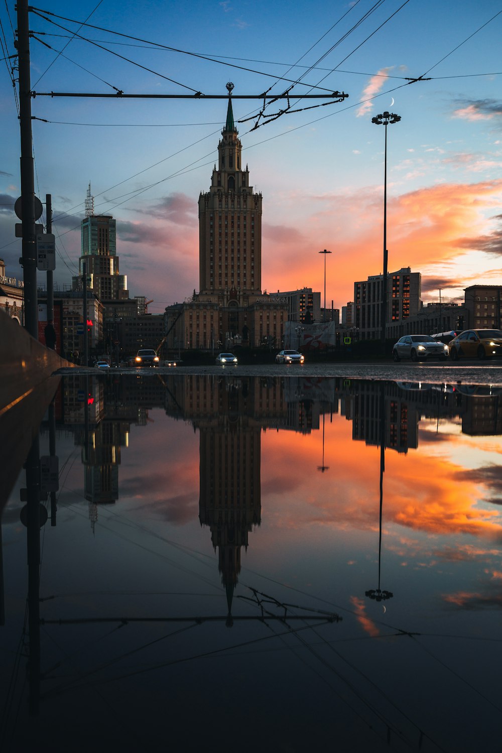 a view of a city at sunset with a reflection in the water
