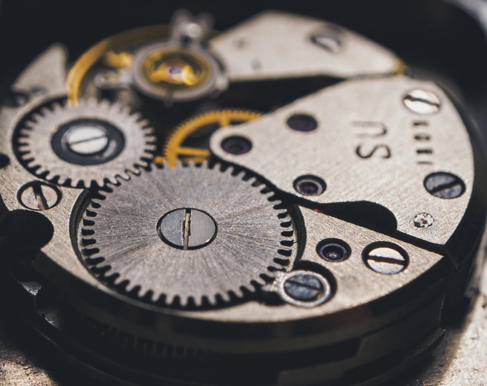 The plates and wheels of a watch movement in close-up