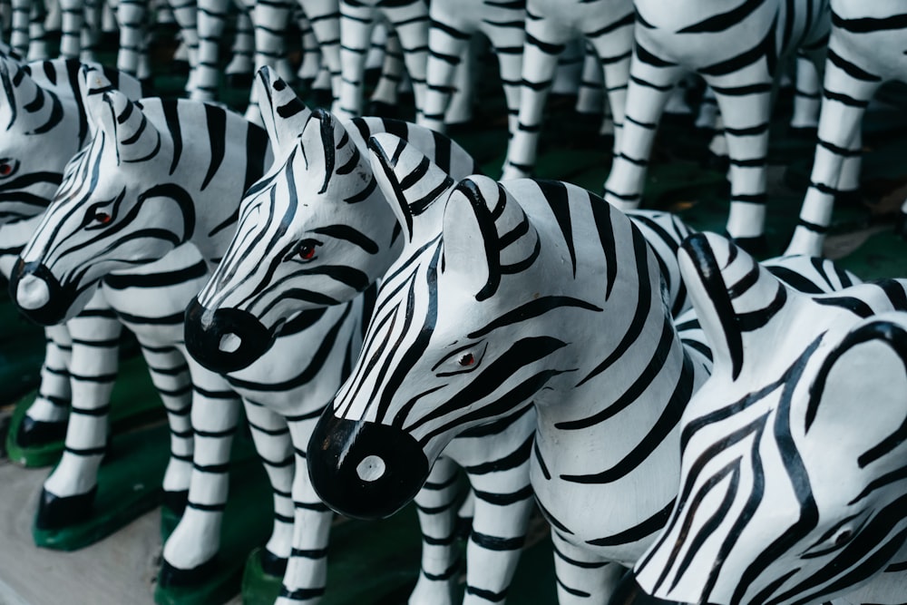 a row of zebra statues sitting on top of each other