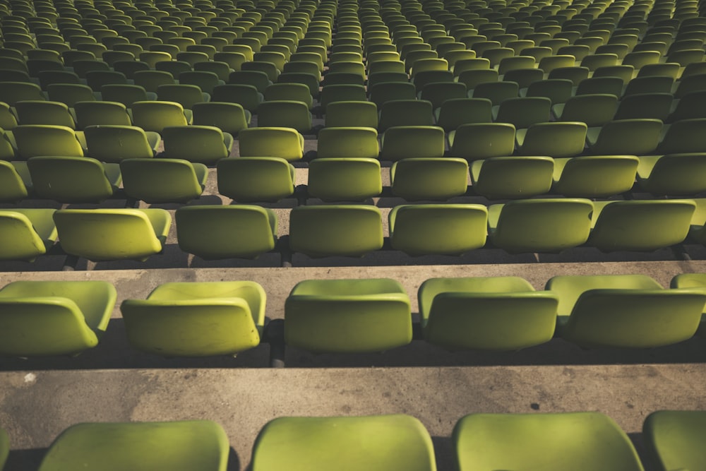 a row of green chairs sitting next to each other