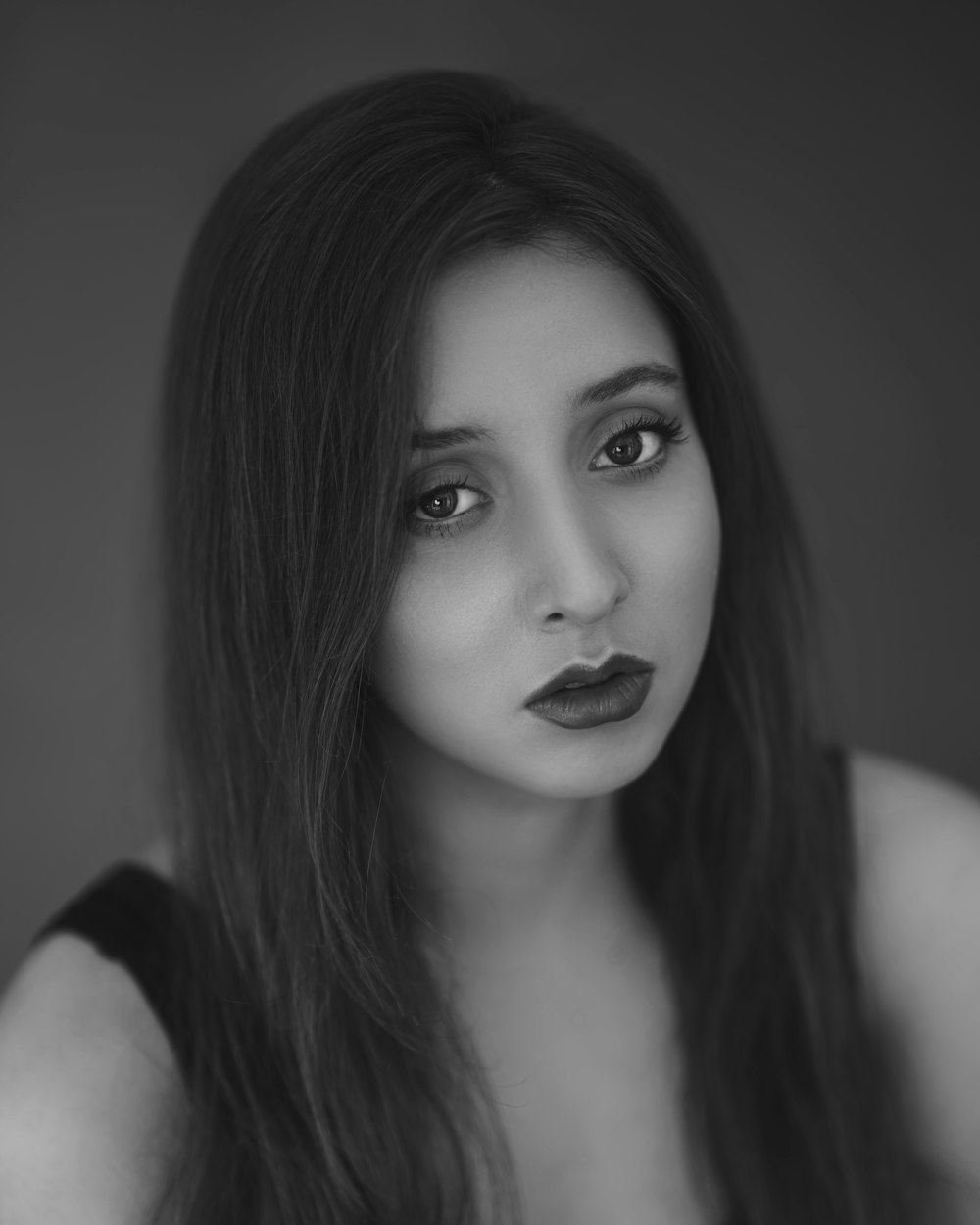 a black and white photo of a woman with long hair