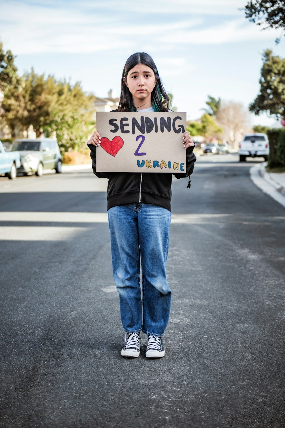 a woman holding a sign that says sending 2 u s