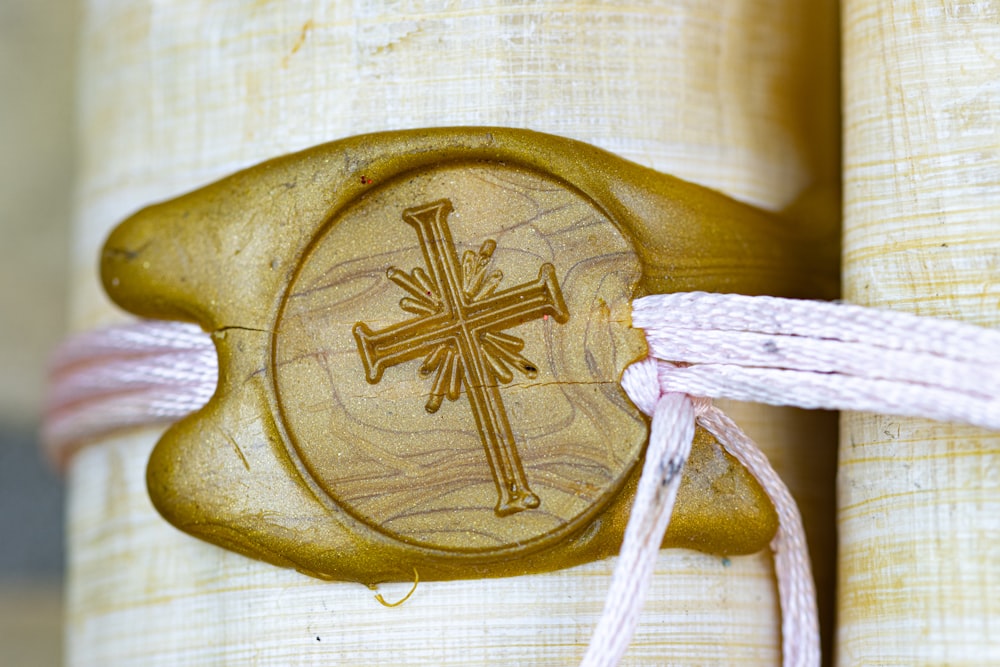a wooden cross with a cord attached to it