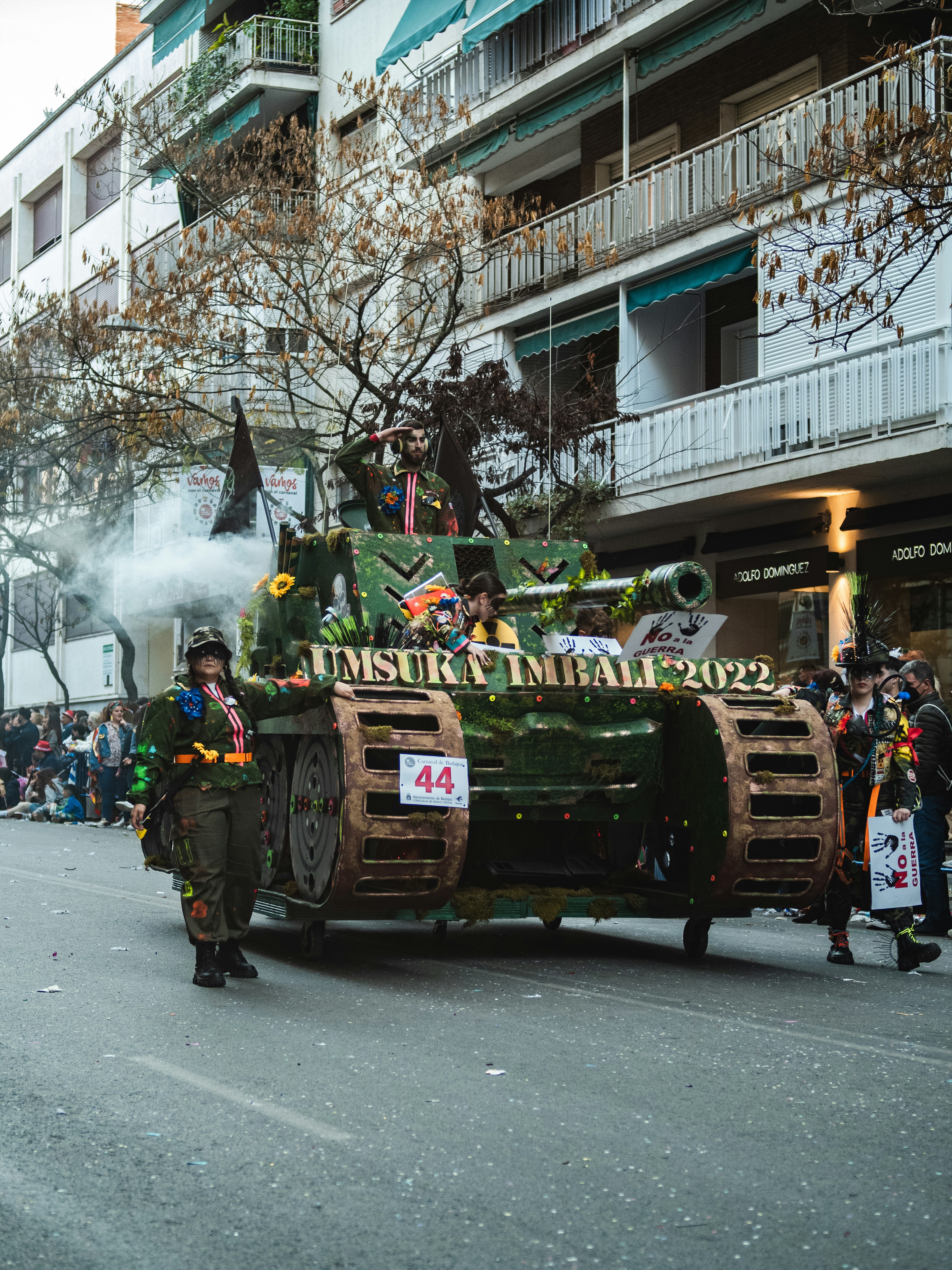 a group of people riding on the back of a green tank