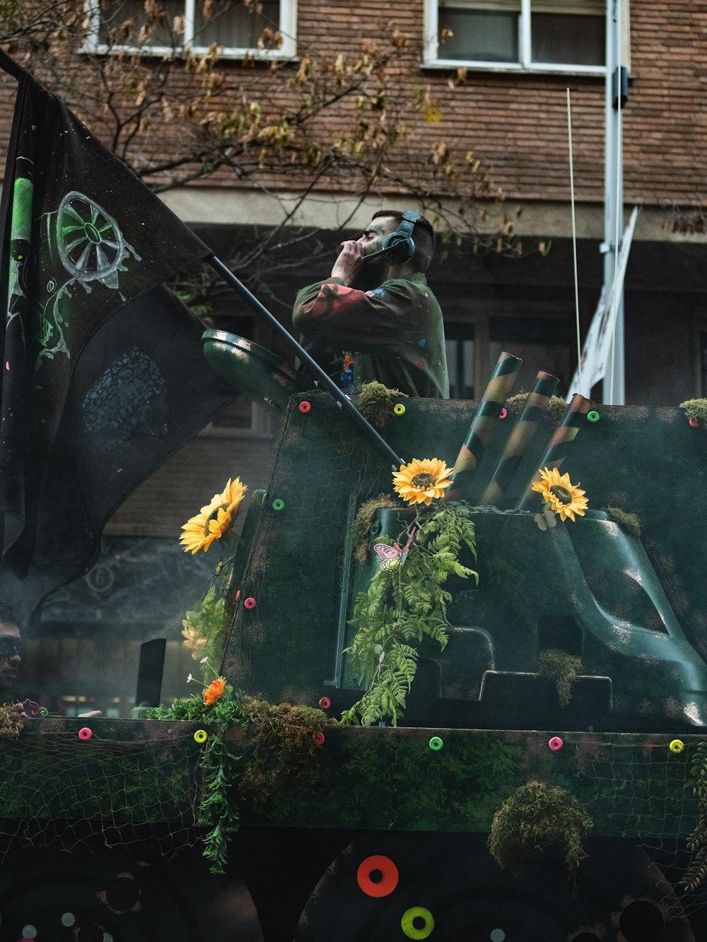 a truck decorated with sunflowers and a flag