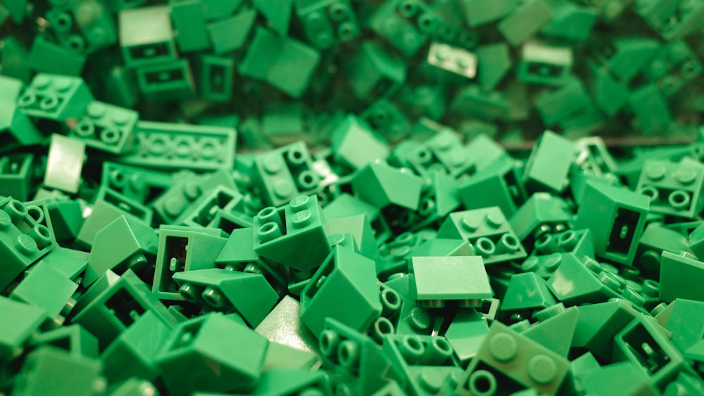 a pile of green lego blocks sitting next to each other