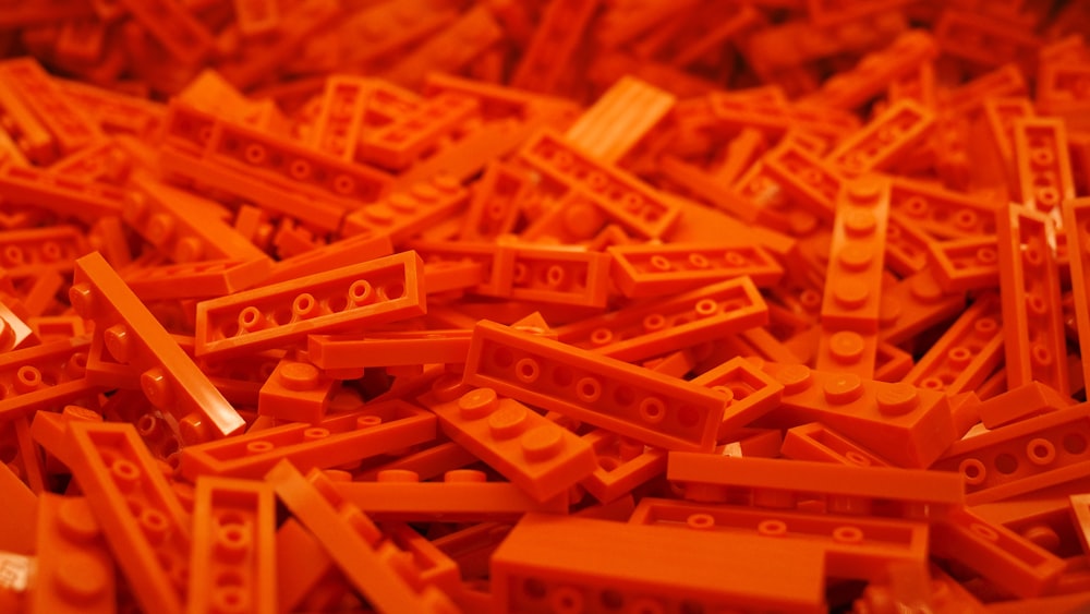 a pile of orange legos sitting on top of a table