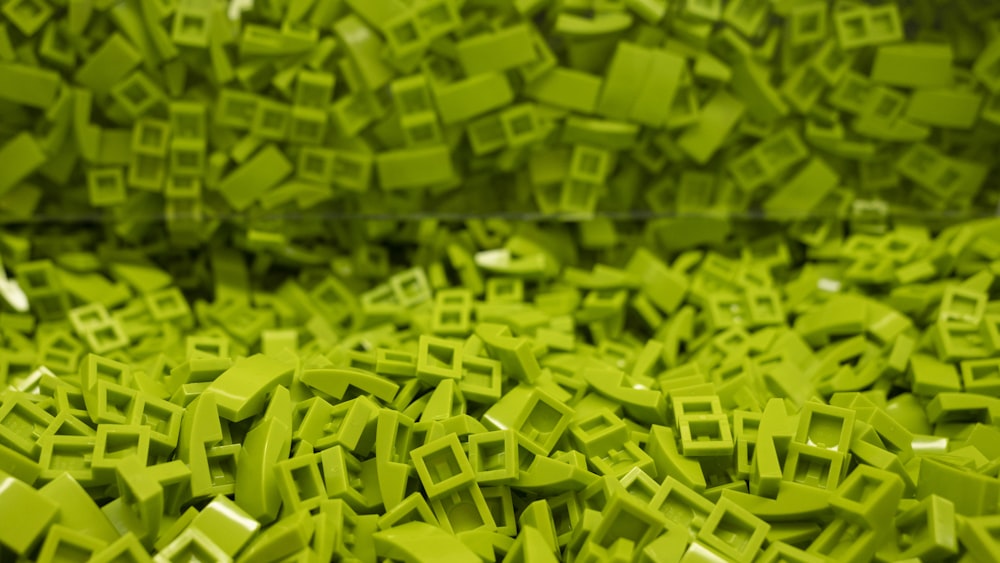 a large pile of green square shaped objects