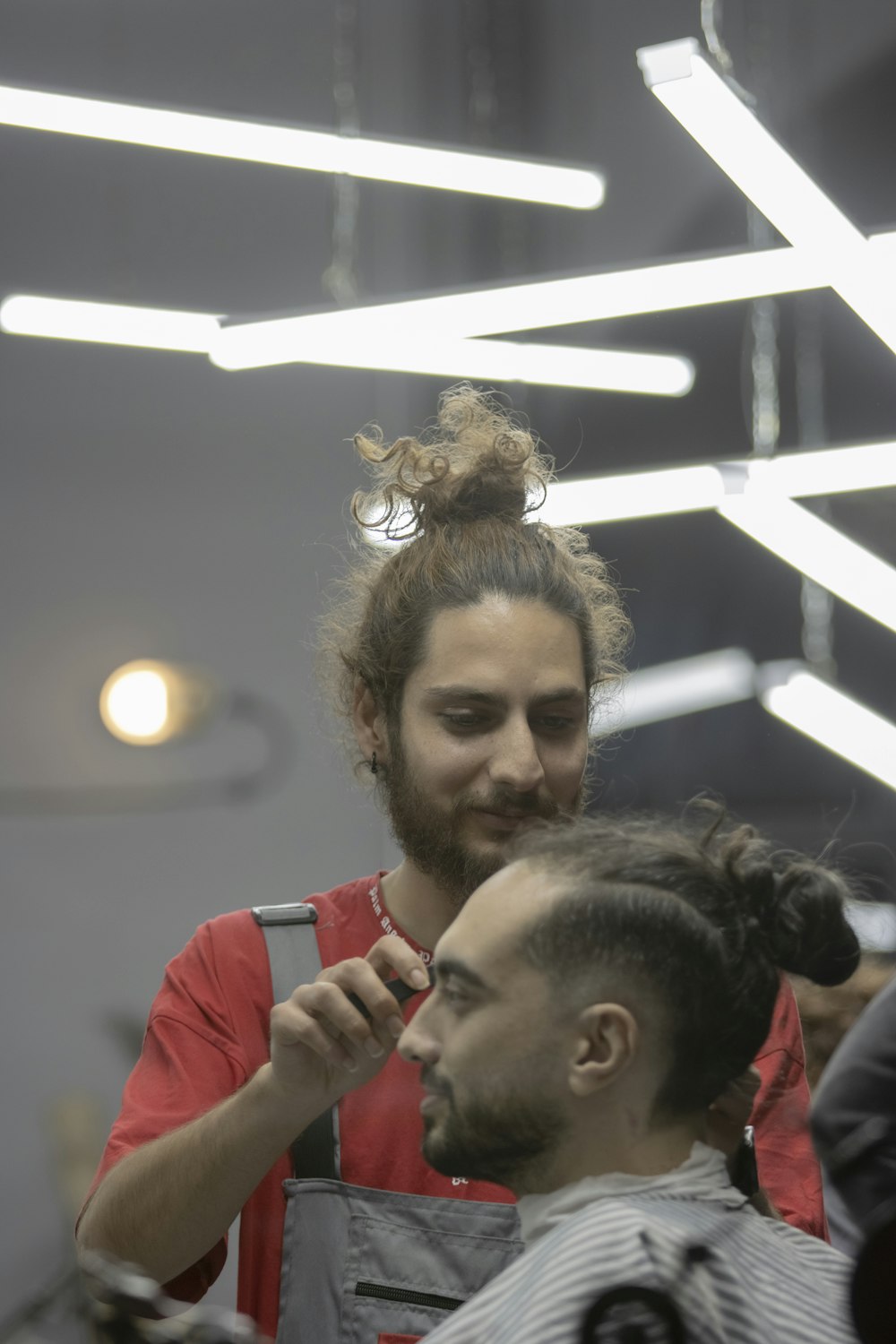 a man getting his hair cut at a barber shop