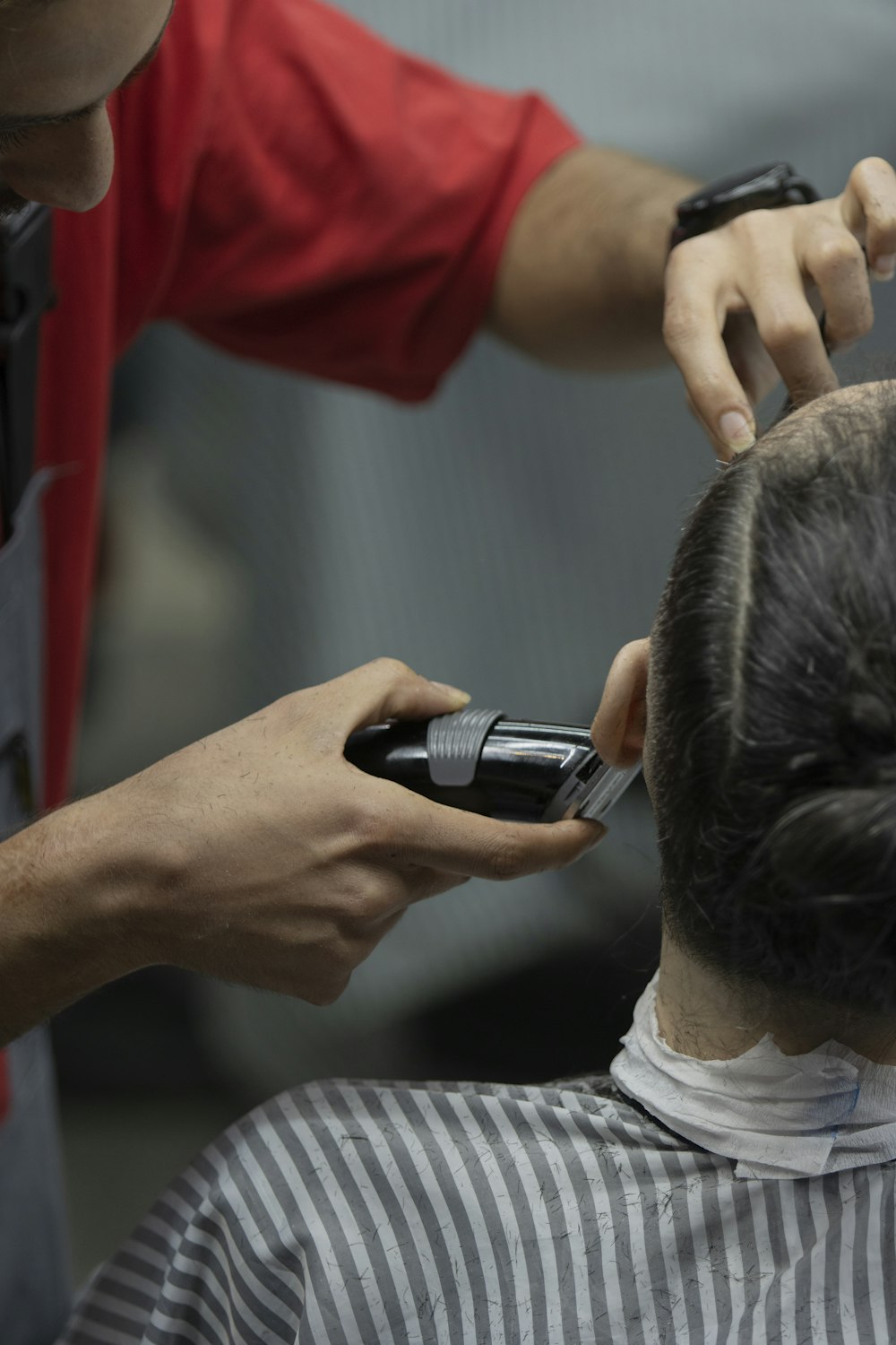 a man getting his hair cut by a barber