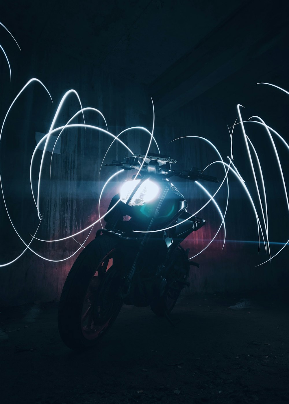 a motorcycle parked in a dark room with a light painting effect