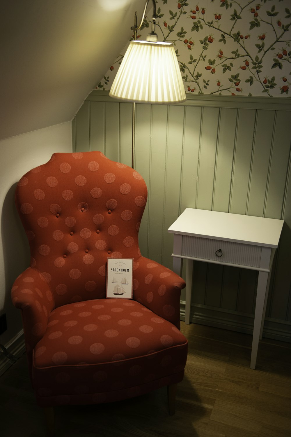 a red chair sitting in a corner of a room