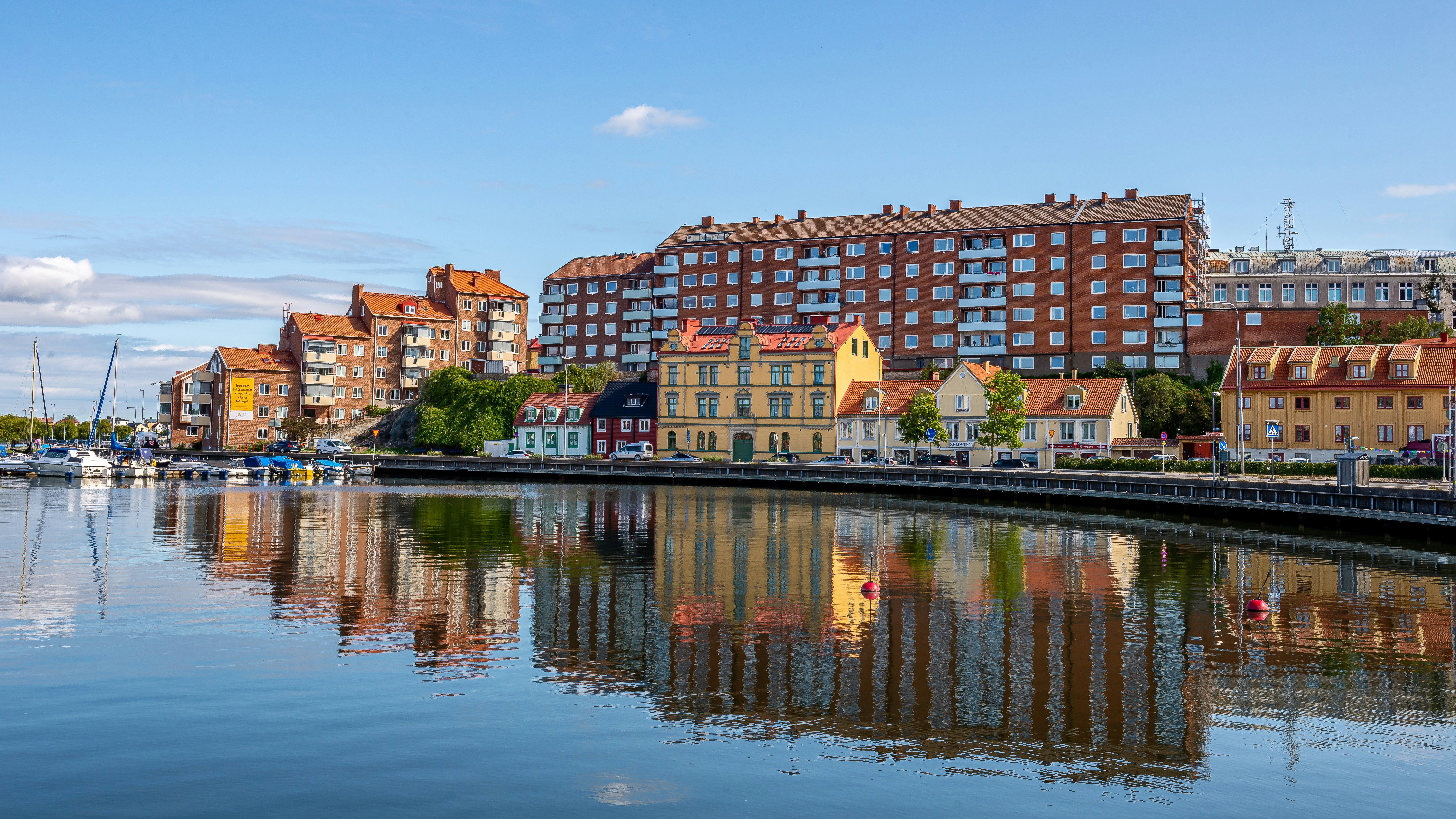 a body of water with buildings in the background, 