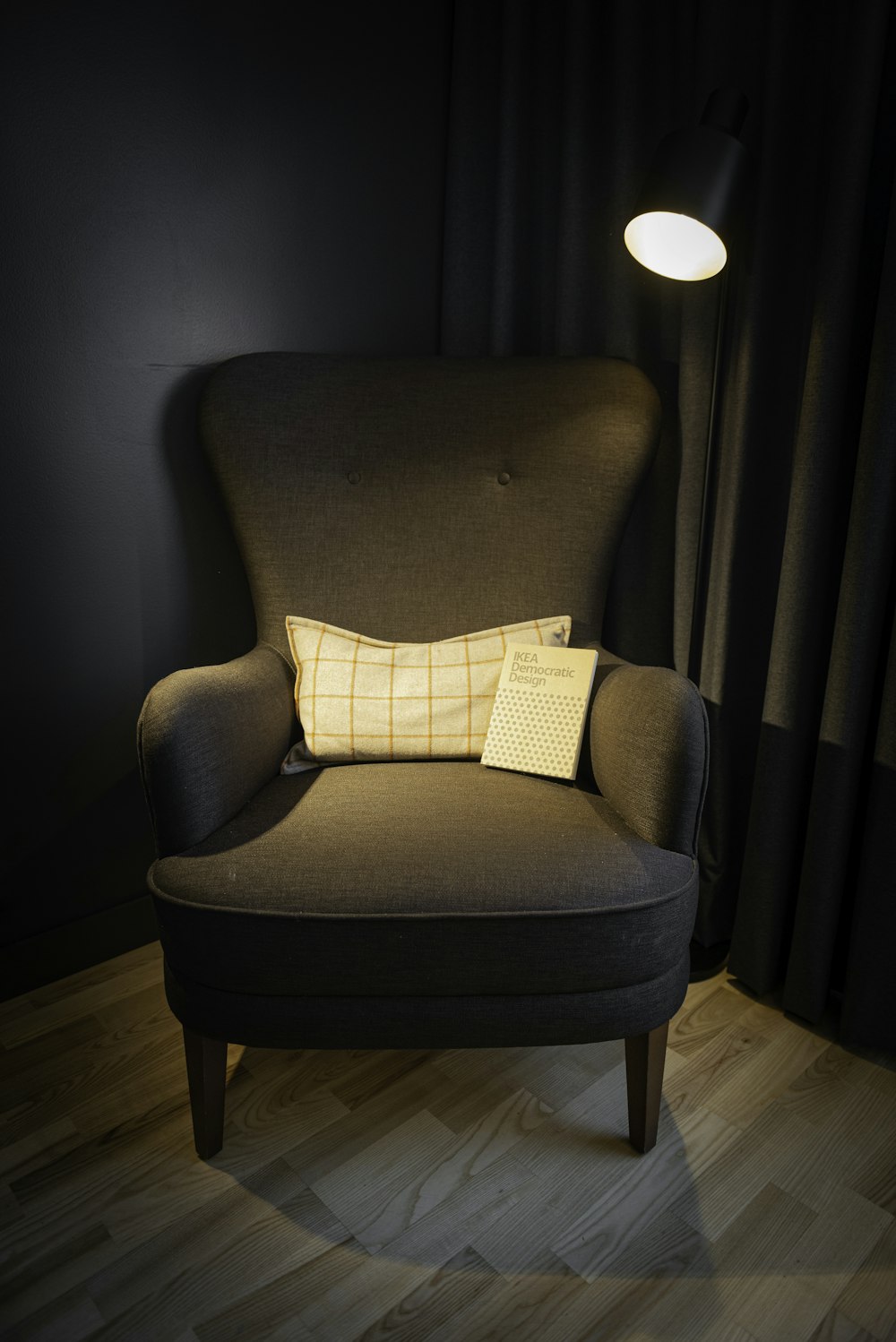 a chair with a pillow on it in a dark room