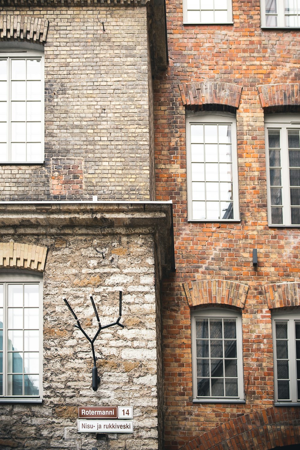 a clock on the side of a brick building