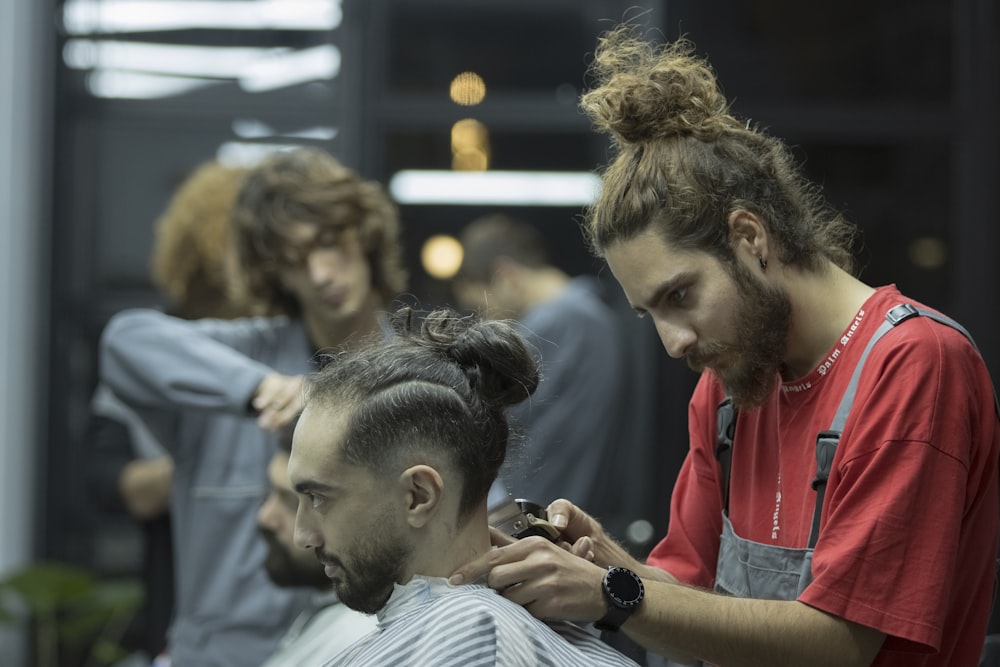 a man getting his hair cut at a barber shop