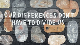 a brick wall with a painted message that says our differences don't have to