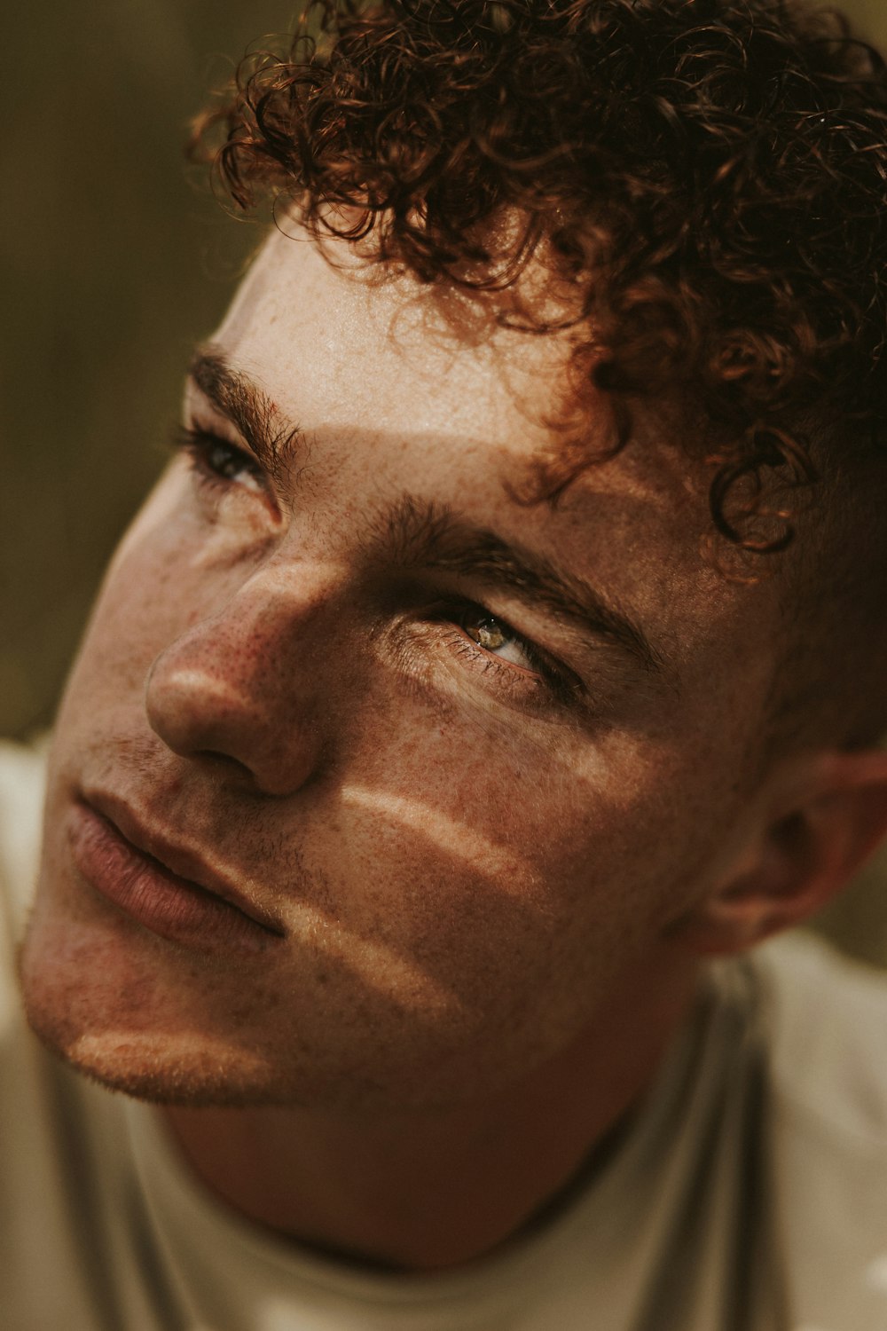 a close up of a man with curly hair