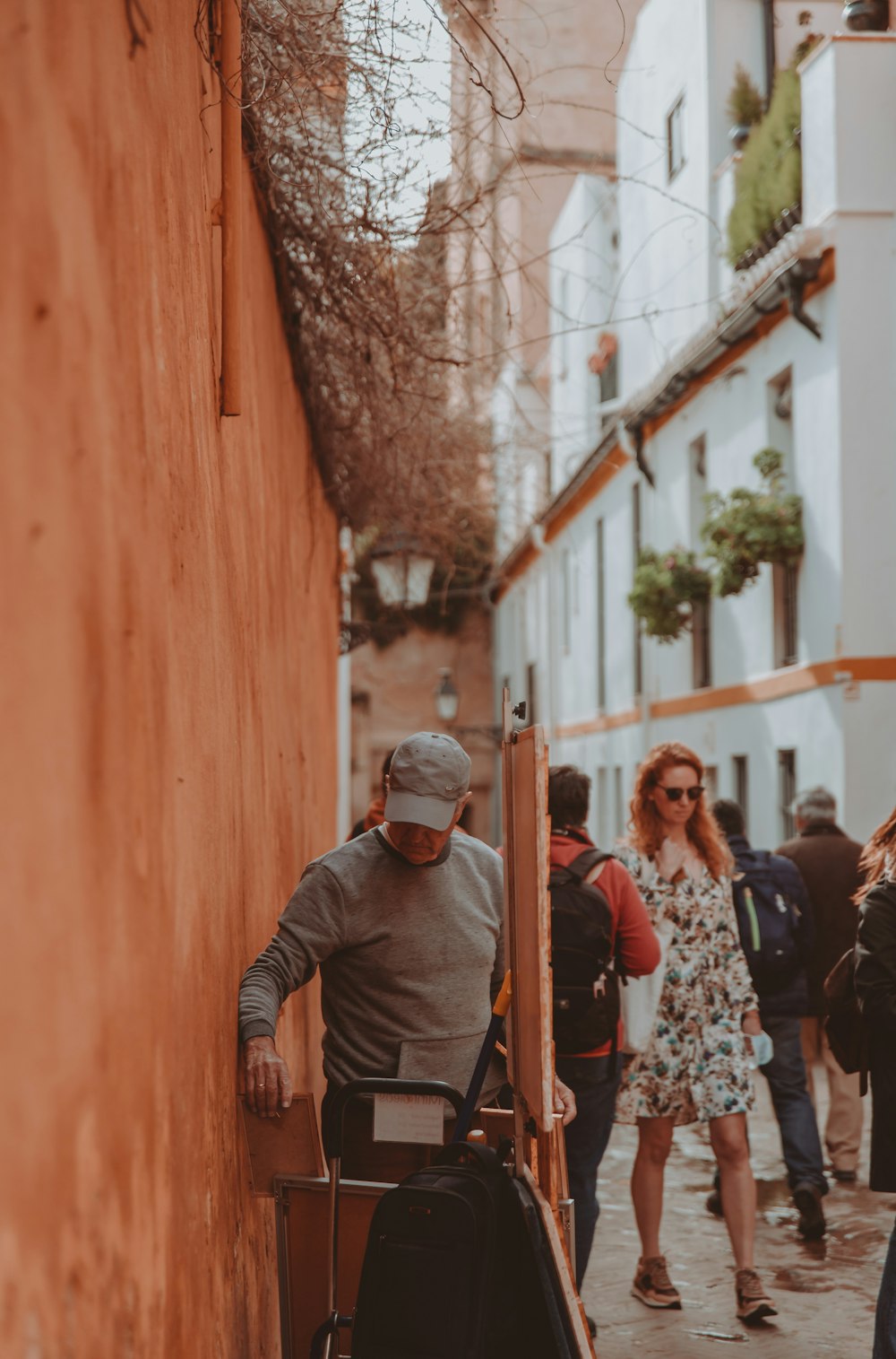 a group of people walking down a street next to a building