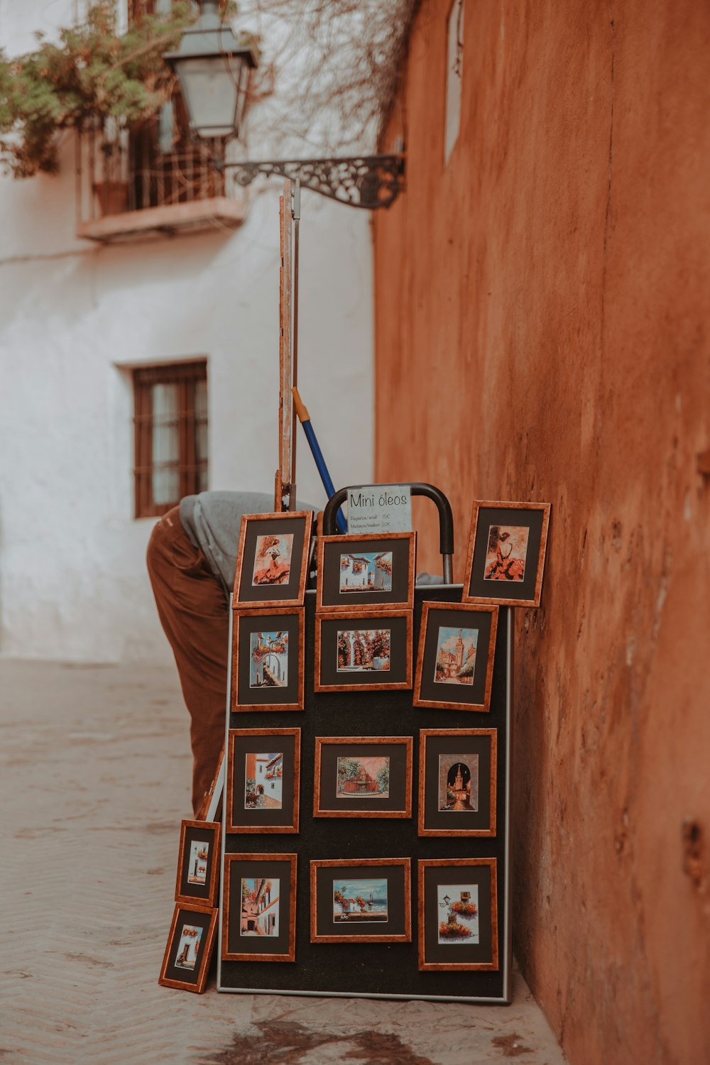 a person leaning against a wall with a bag on it