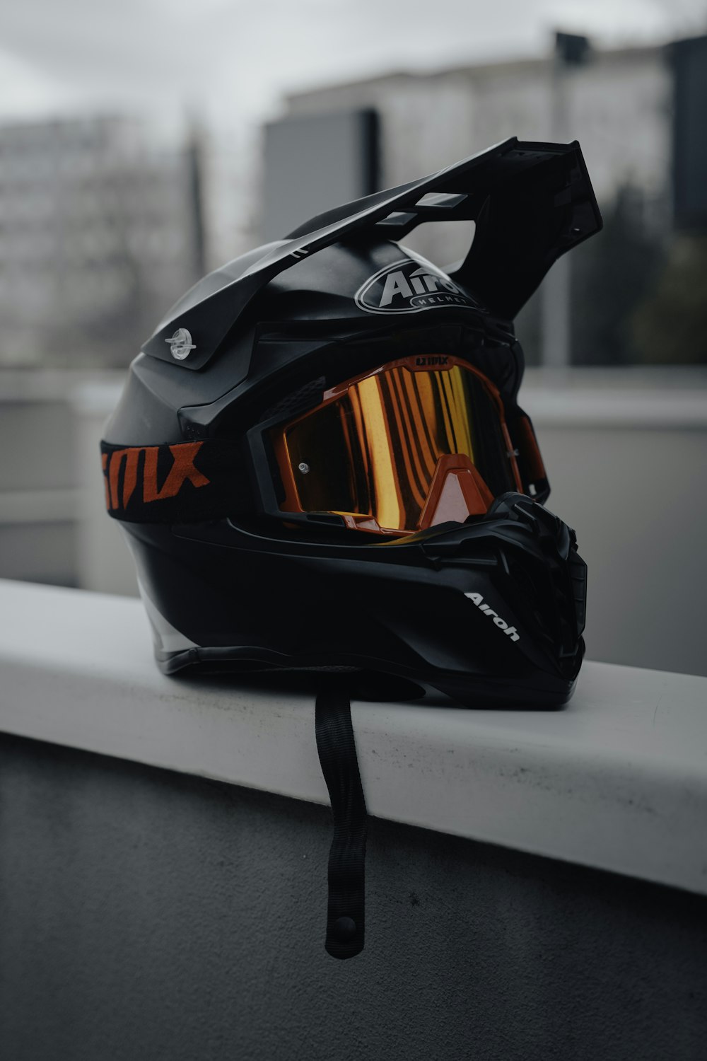 a helmet and goggles are sitting on a ledge